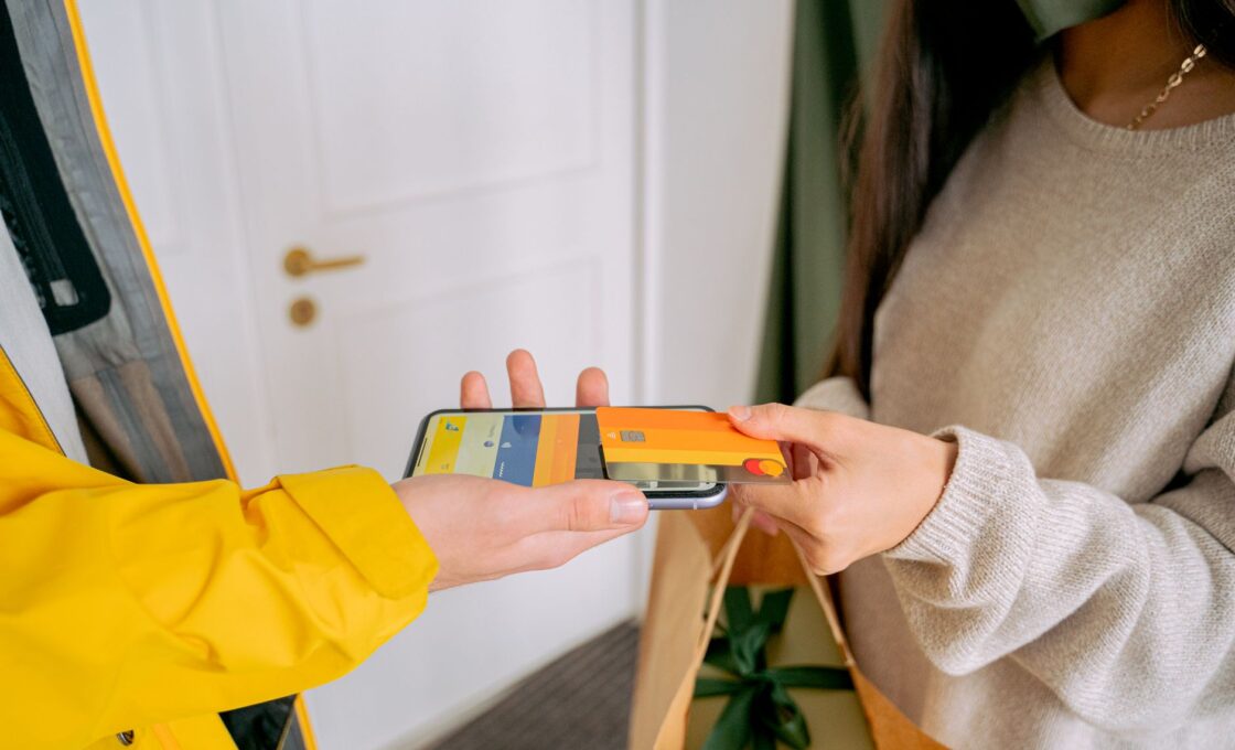 Woman shopping online for gifts with a phone during the holidays