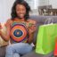 Woman shopping online with a phone and credit card at home