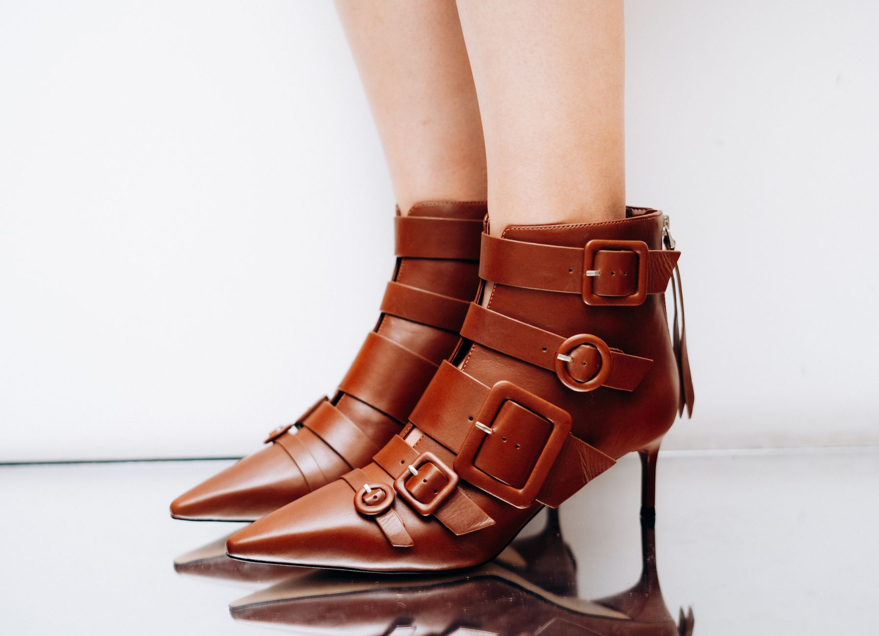 A pair of leather ankle boots styled for fall
