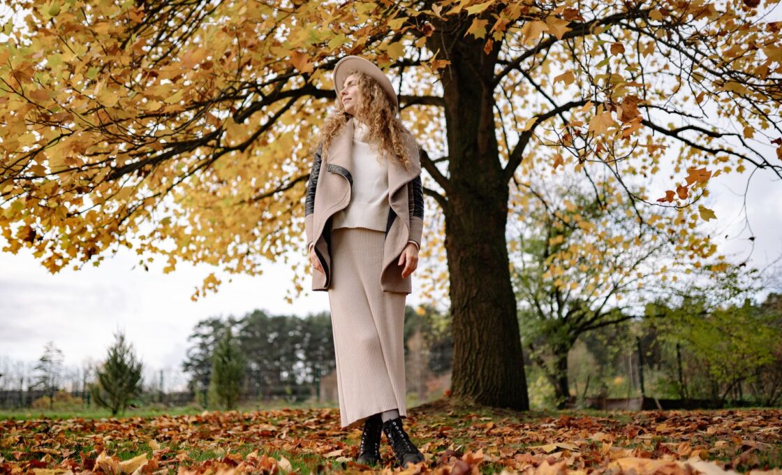 Woman in a fall outfit choosing clothes from her wardrobe