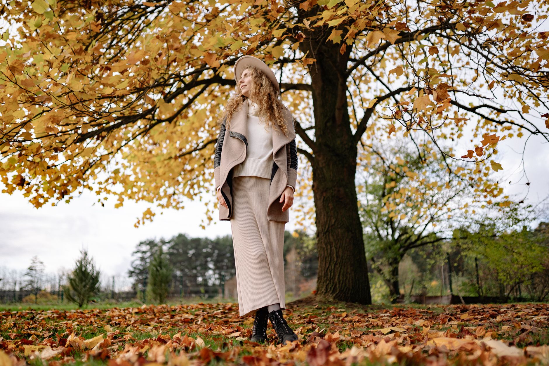 Woman in a fall outfit choosing clothes from her wardrobe