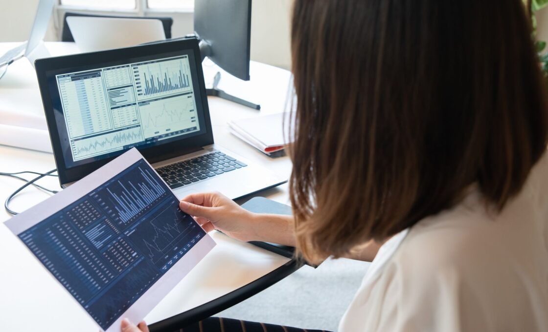 Woman reviewing investment accounts on a laptop at home