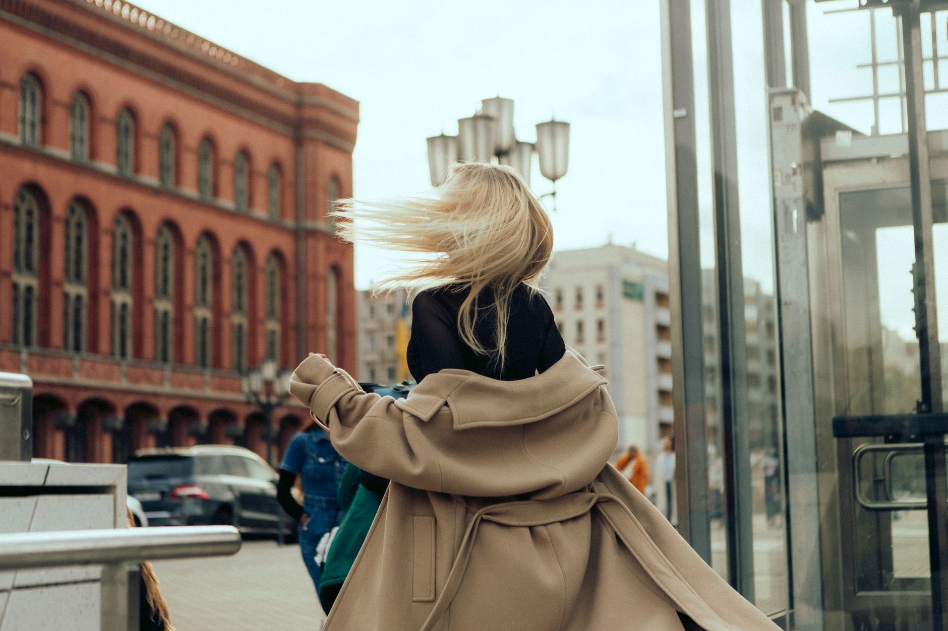 Woman exploring a European city street during shoulder season travel in early autumn
