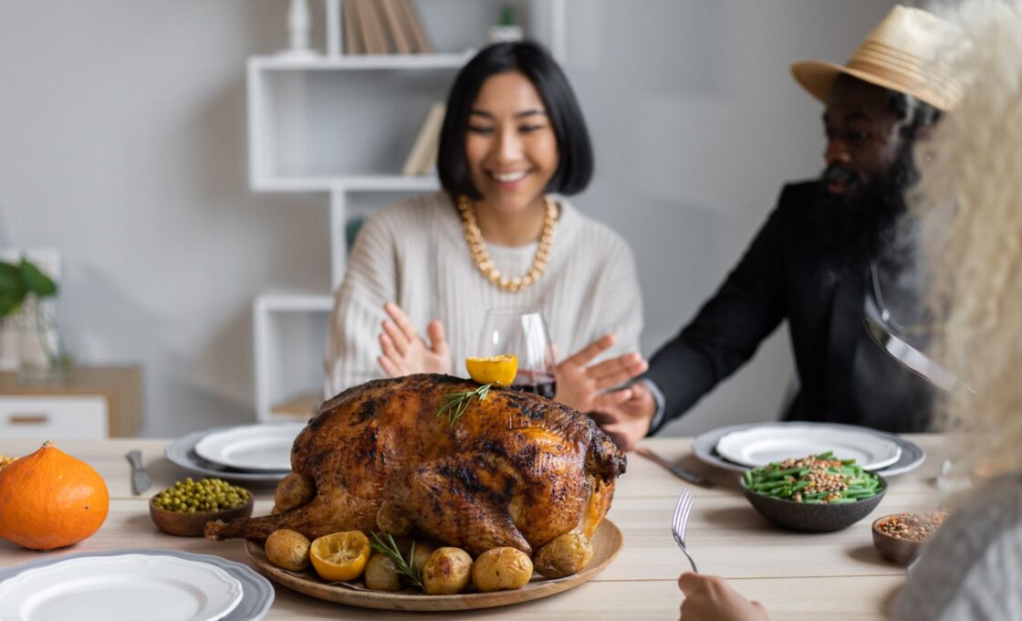 Roast Thanksgiving turkey on a family dinner table, illustrating the fresh vs frozen turkey decision