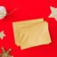 Gold holiday envelopes on a red background, ready for holiday tips