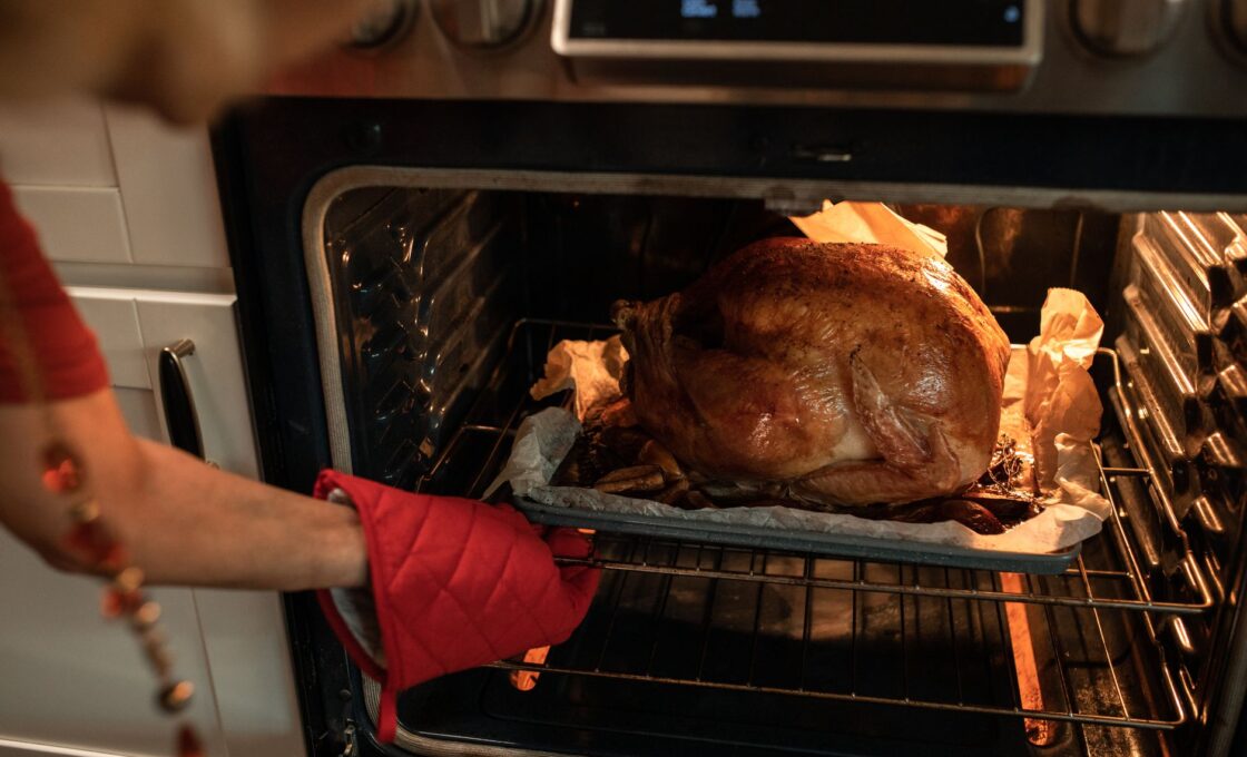 Roasted Thanksgiving turkey coming out of the oven, when the two-hour leftovers clock starts