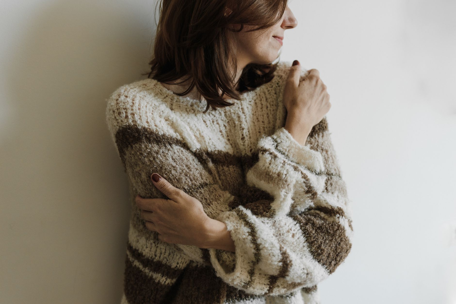 Woman wearing a soft knit sweater, illustrating how to tell good cashmere from pill-prone knits