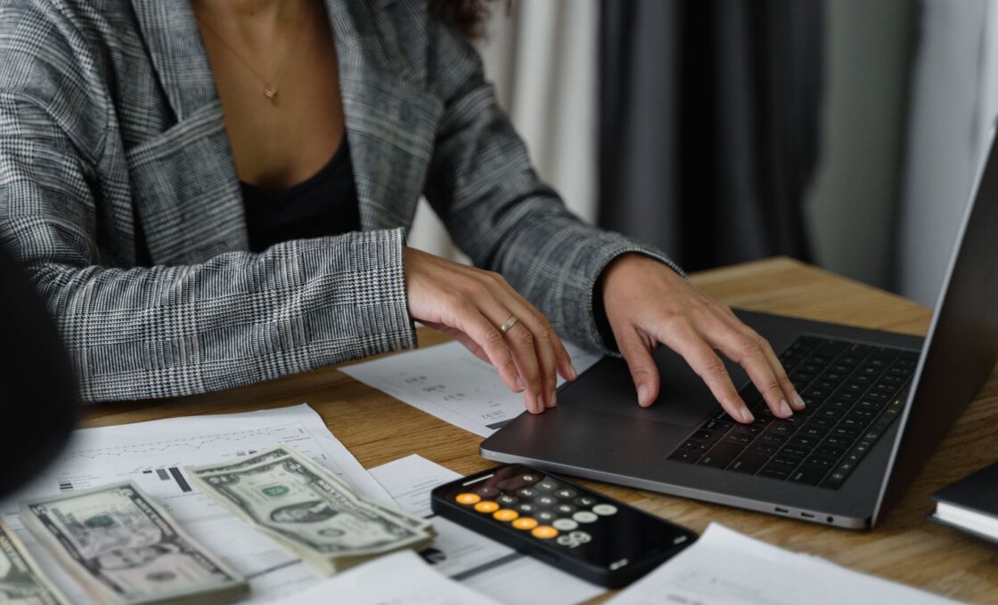 Woman reviewing her savings on a laptop while planning an I bond purchase
