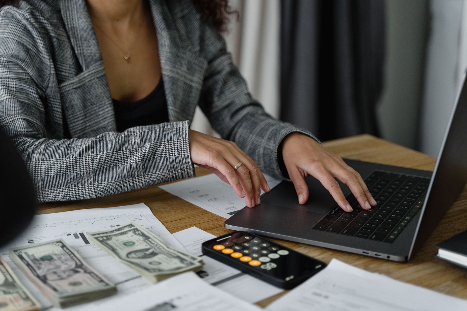 Woman reviewing her savings on a laptop while planning an I bond purchase