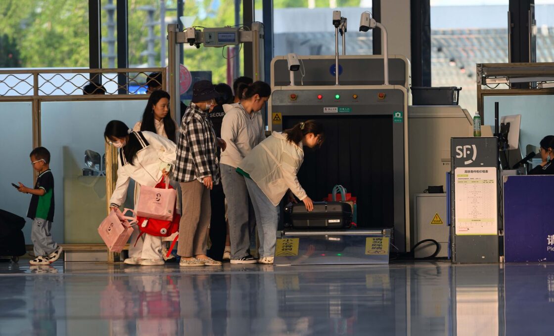 Travelers going through an airport security checkpoint, comparing TSA PreCheck and Global Entry lines