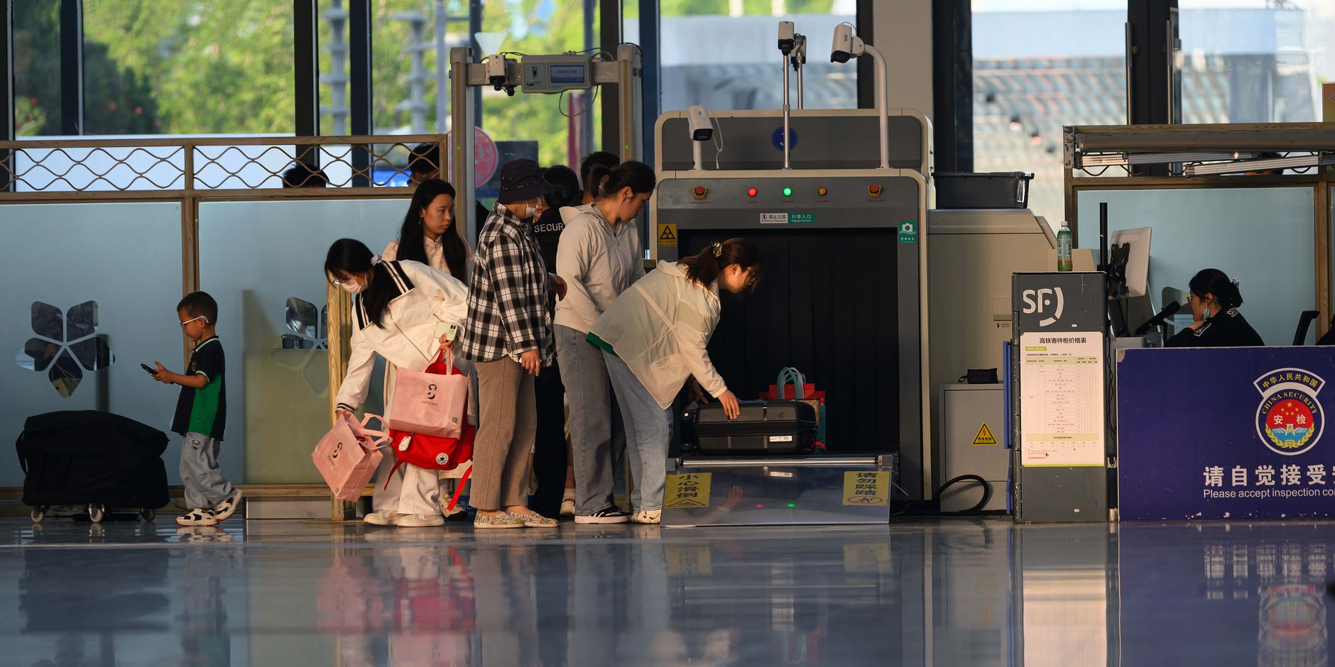 Travelers going through an airport security checkpoint, comparing TSA PreCheck and Global Entry lines